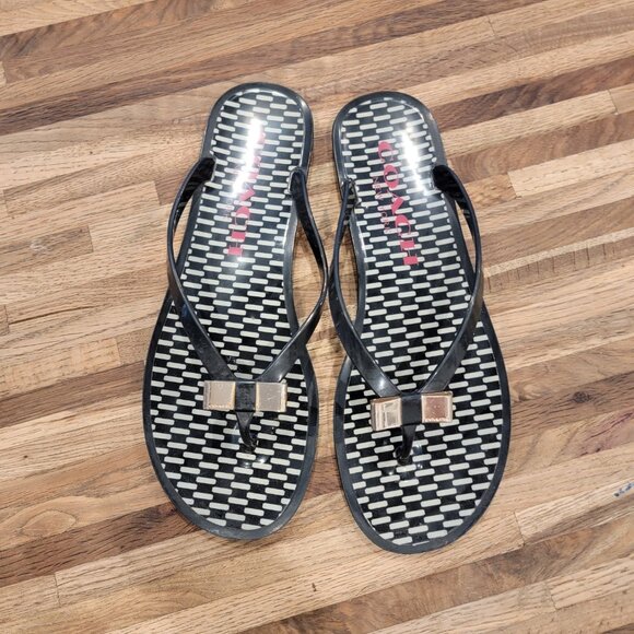 Coach Landon jelly flip flops in black with a gold bow and white pattern. - Picture 3 of 12